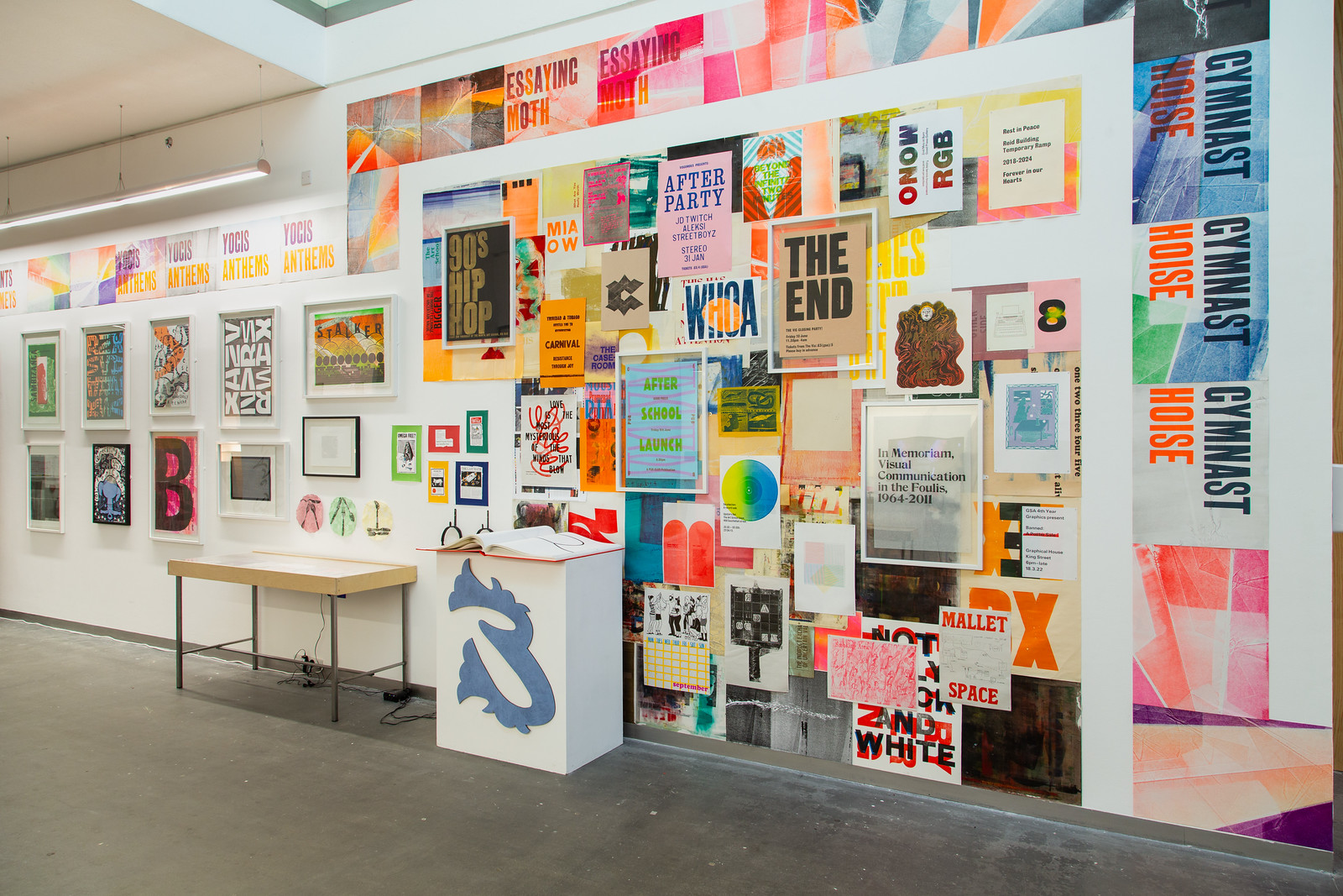 Colourful letterpress posters displayed along a gallery wall