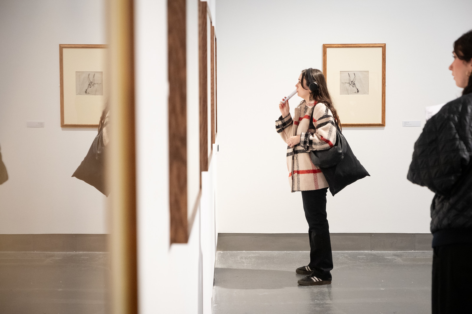 Visitors looking at framed works in the Early Eardley exhibition